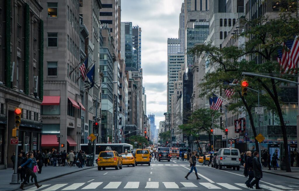 A street in New York where a crosswalk and taxis can be seen