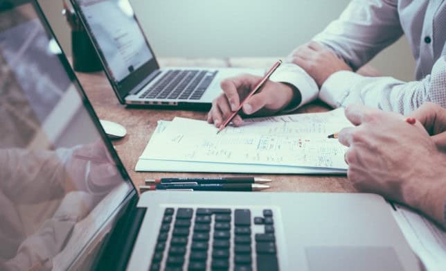  Business professionals review customer data generated by advanced contact center software 